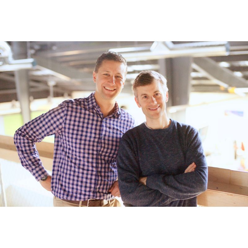 Owners of Saratoga Health Wellness Fitness Facility on mezzanine overlooking their gym