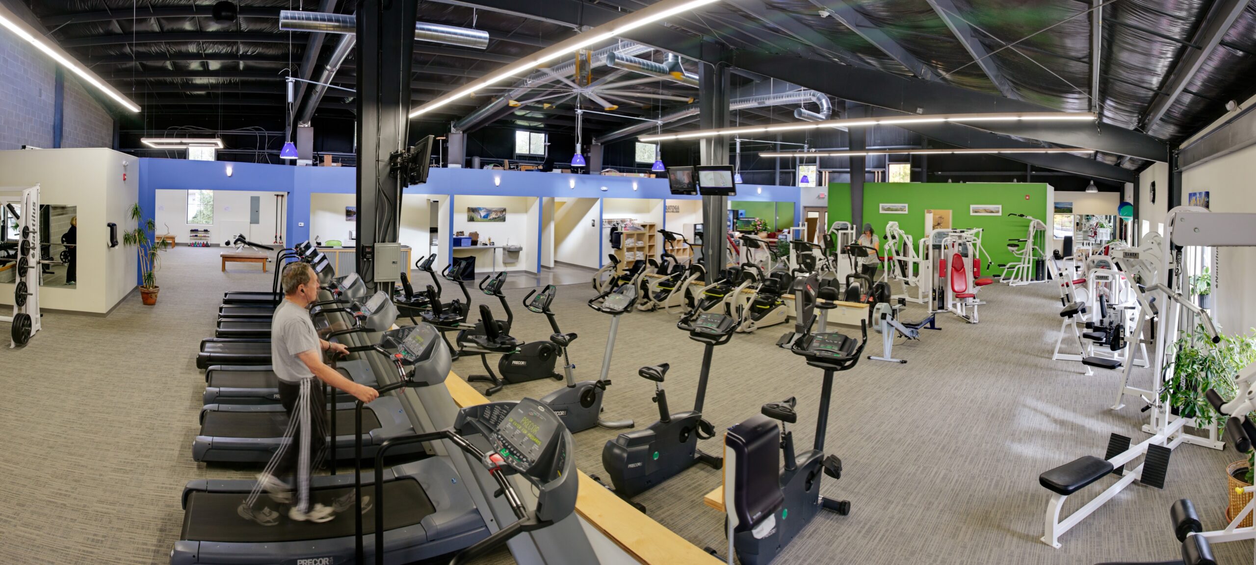 Cybex and nautilus strength training equipment along the windows with ample floor space for precor cardio - spacious facility